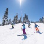 Family Skiing Down Mountain
